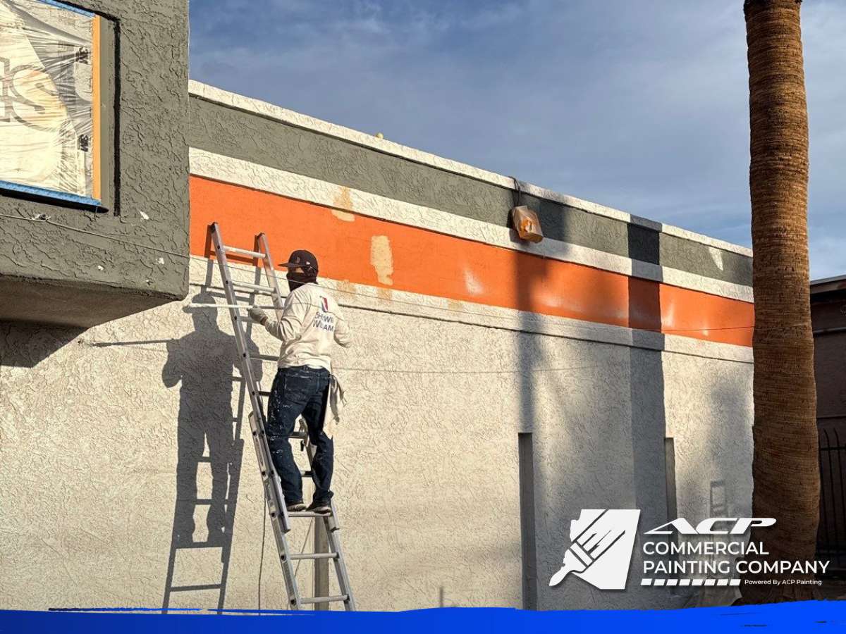 Commercial Building Repaint Arizona with worker on ladder painting exterior wall
