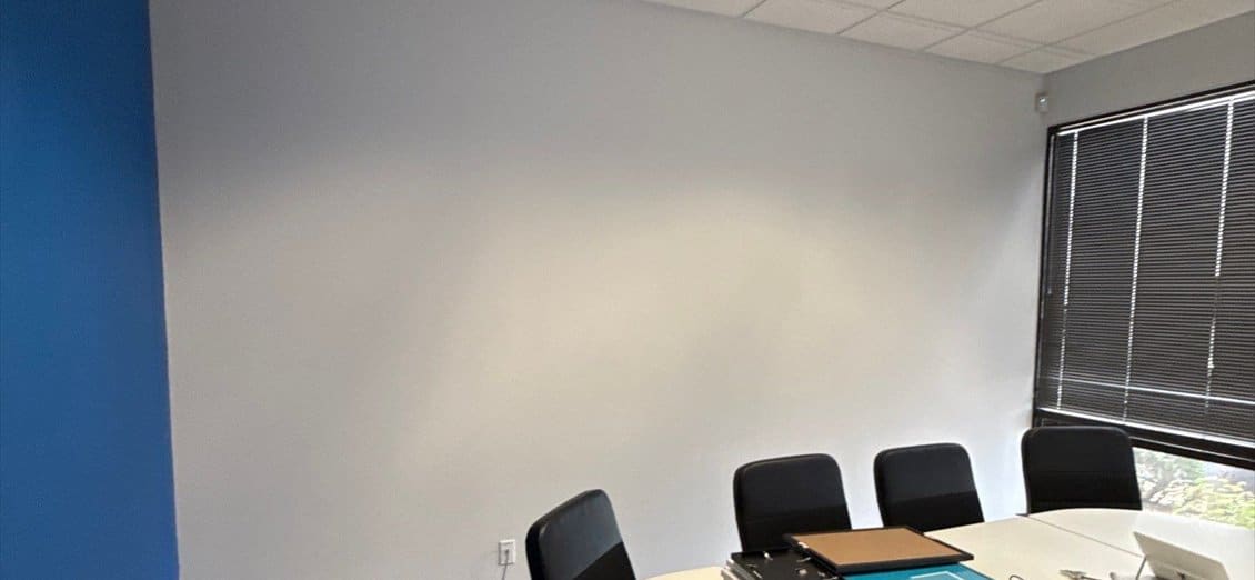 Corporate conference room with a blue accent wall repainted by ACP Commercial Painting Company in Tempe, AZ