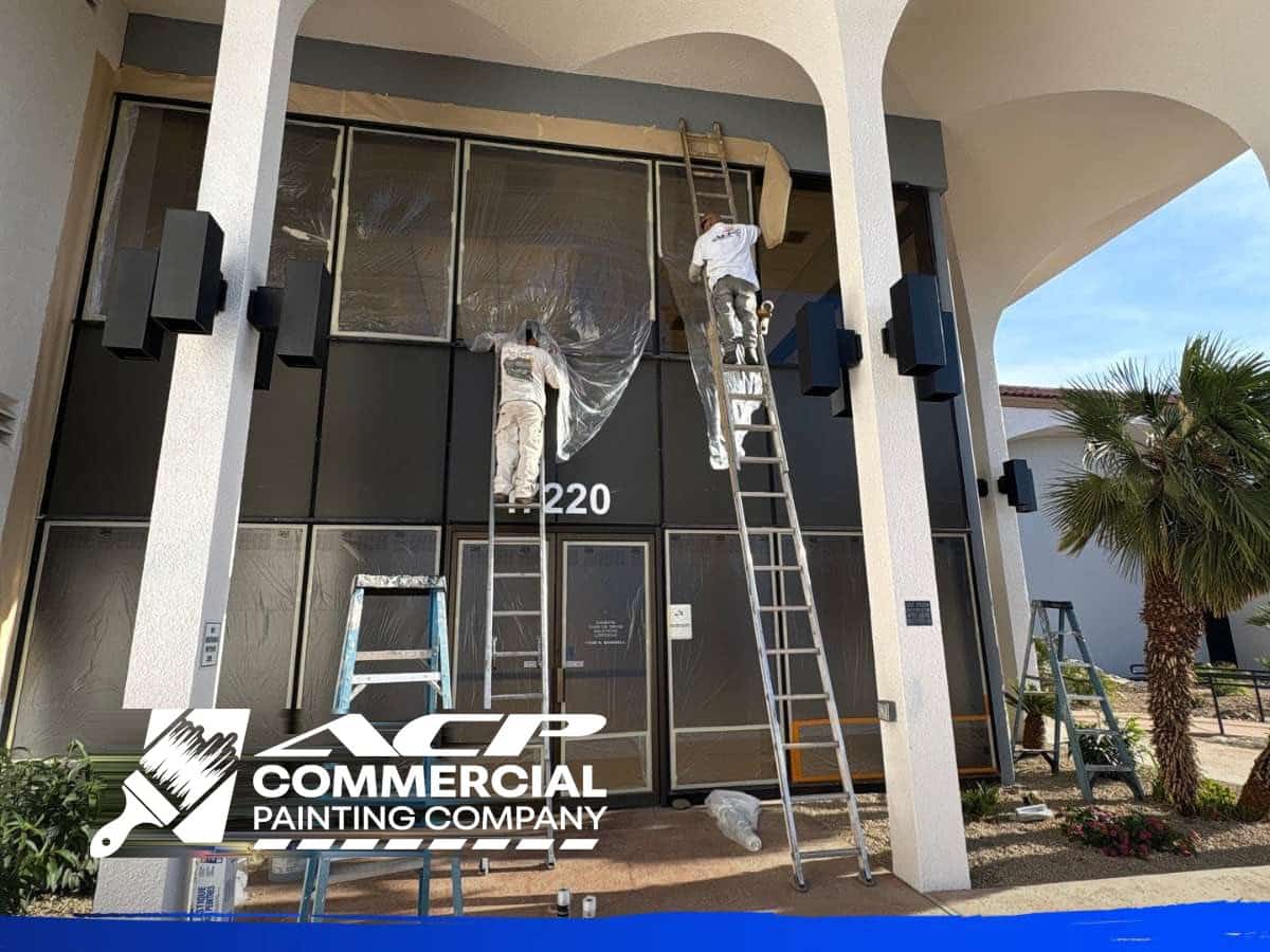 Painters masking and repainting the entrance of an occupied Phoenix office, ACP Commercial Painting Company