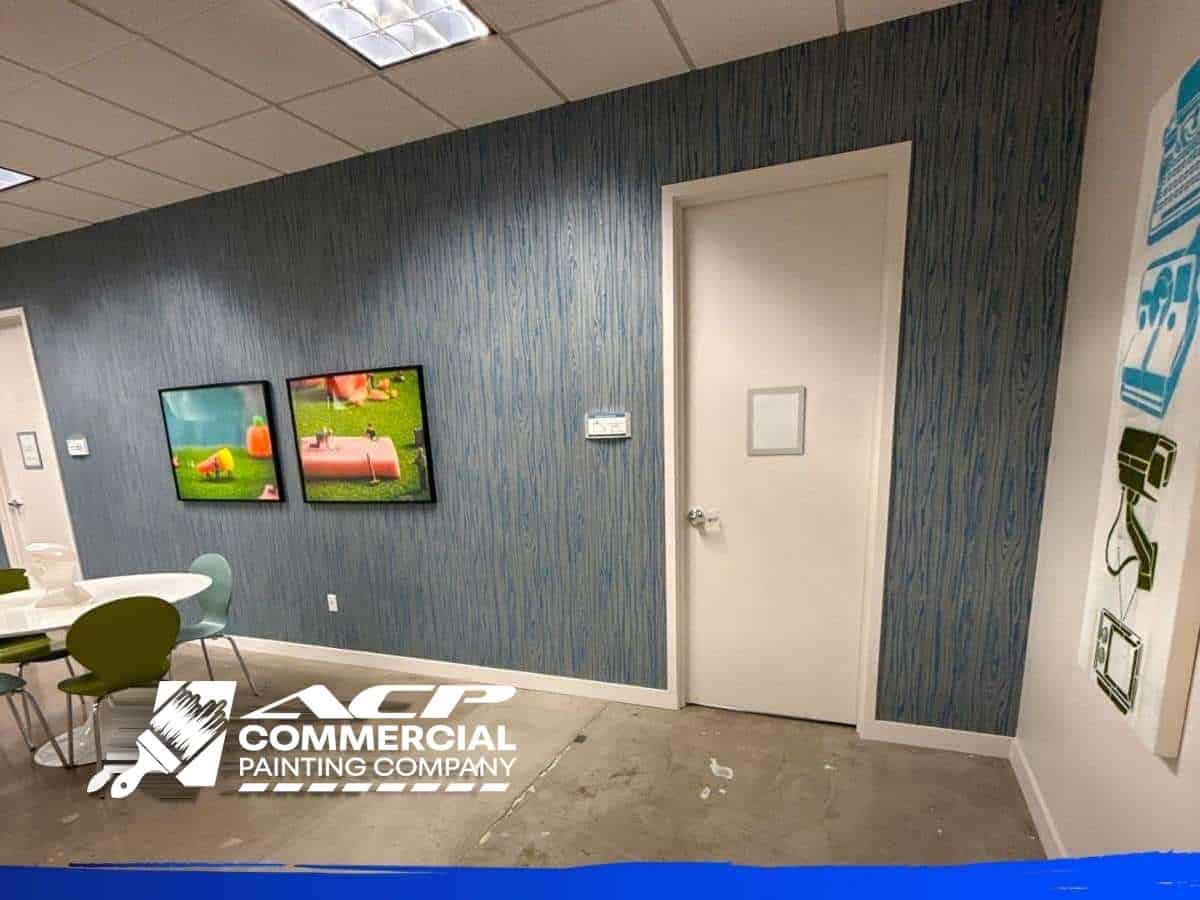 Office interior with a blue-gray accent wall painted by ACP Commercial Painting Company